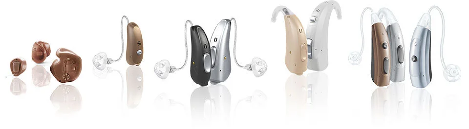 A selection of modern in-ear and behind-the-ear hearing aids
